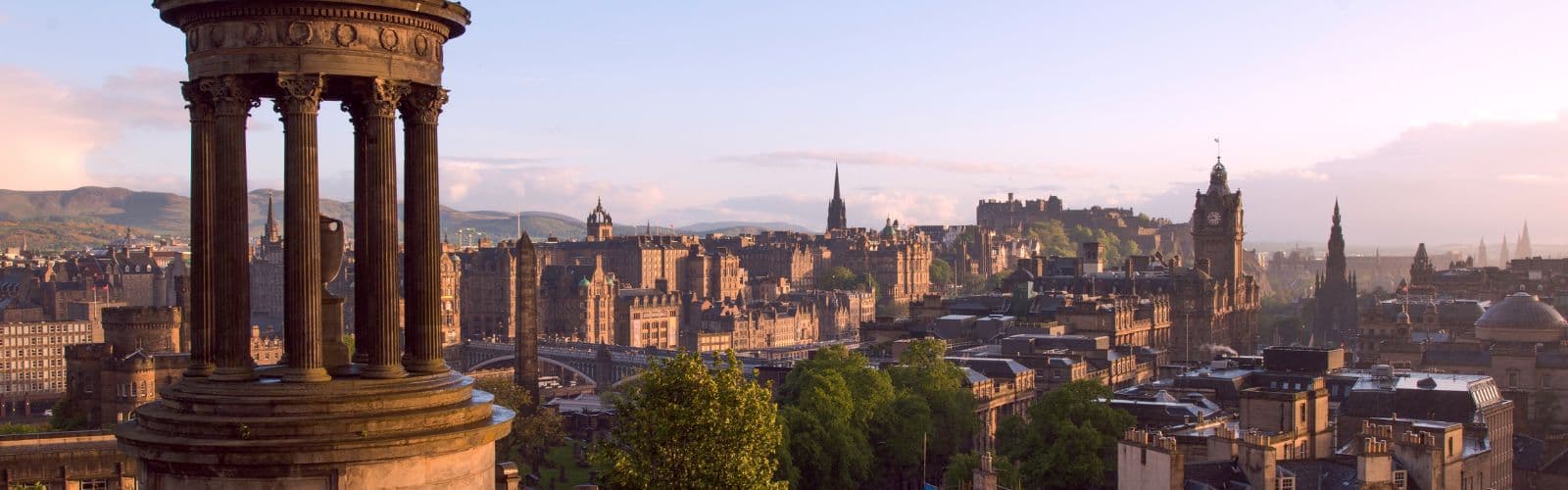 The skyline of Edinburgh, with the top of a bell tower in the foreground. 